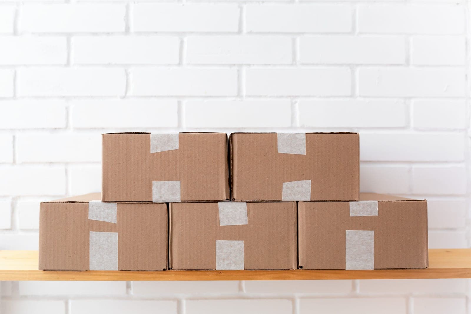 Brown cardboard parcels stacked on a wooden surface