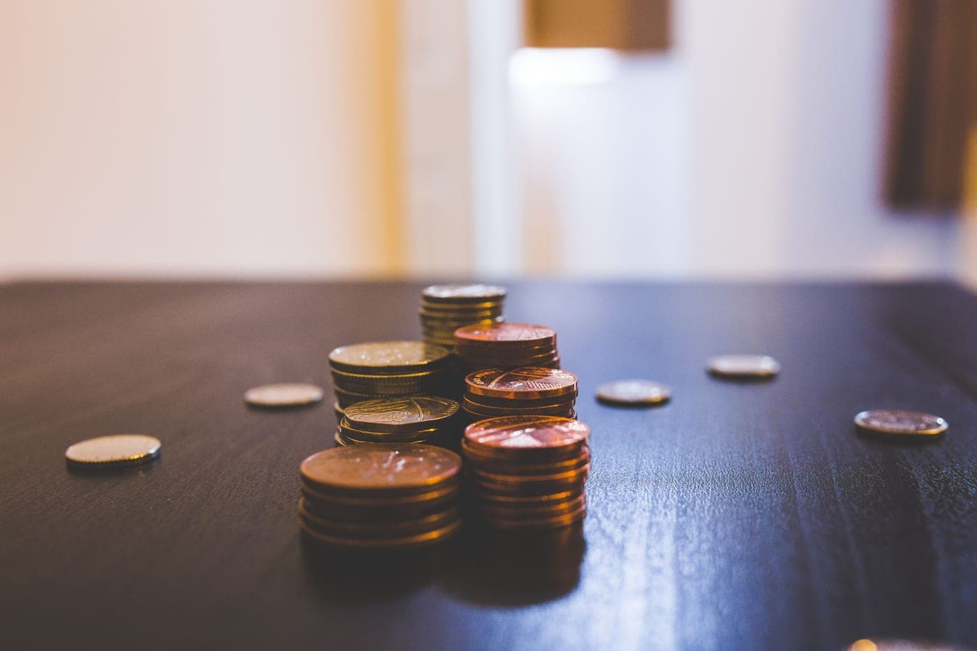 Coins stacked on a dark tabletop